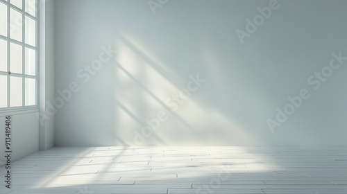 A large, empty room with a window that lets in a lot of light photo