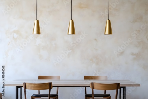 Minimalist interior design of modern dining room with brass pendant lights against beige stucco wall.