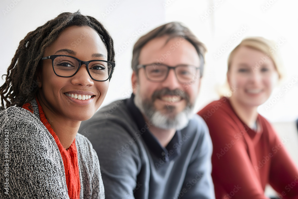 Colleagues smiling together in modern office setting during work hours Colleagues smiling together in modern office setting during work hours