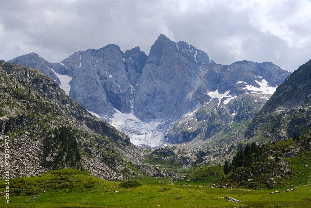 Beautiful scenery of Pyrenees National Park. Tourist trail to Refuge des Oulettes de Gaube around mountain massif with glacier Oulettes and Vignemale - the highest peak of French Pyrenees. Beautiful scenery of Pyrenees National Park. Tourist trail to Refuge des Oulettes de Gaube around mountain massif with glacier Oulettes and Vignemale - the highest peak of French Pyrenees.