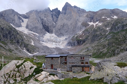 Refuge des Oulettes de Gaube  and mountain massif with Vignemale -the highest peak of French Pyrenees on background. Pyrenees National Park, France photo