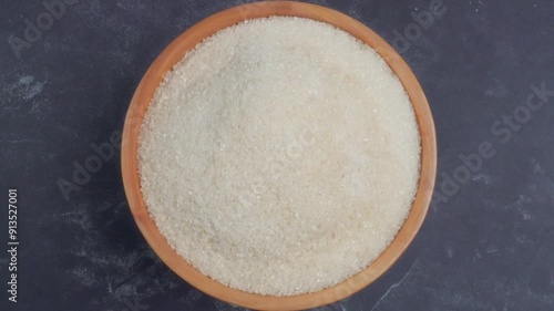 overhead shot view of a spinning wooden bowl of sugar