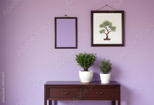 A wooden frame on a white shelf with a small potted plant and a white vase