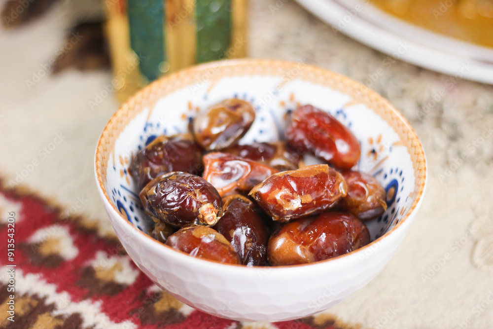Selective focus of delicious dried dates (Kurma) in the bowl. Special Dish Served during Ramadan and Eid Mubarak Selective focus of delicious dried dates (Kurma) in the bowl. Special Dish Served during Ramadan and Eid Mubarak