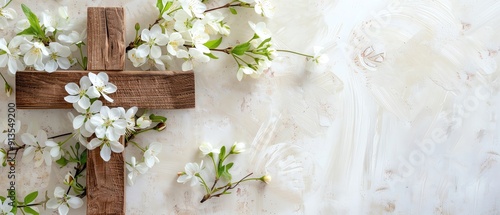 Wooden cross with white flowers on a light background, symbolizing peace