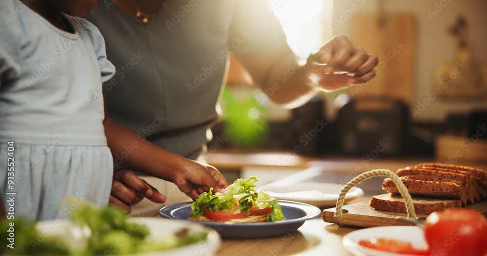 Family, mother and girl in kitchen, lunch and healthy meal with ingredients, learning and morning. Single parent, closeup or mama with daughter, sandwich and home for food, bonding together or hungry Family, mother and girl in kitchen, lunch and healthy meal with ingredients, learning and morning. Single parent, closeup or mama with daughter, sandwich and home for food, bonding together or hungry