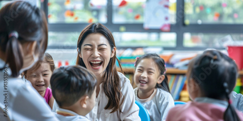 A teacher laughs with her students in a classroom. They are all smiles and enjoying the learning experience together.. asian woman