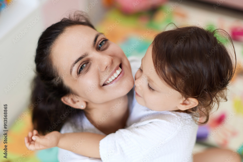 happy mother with cute baby girl in white t-shirt having fun together