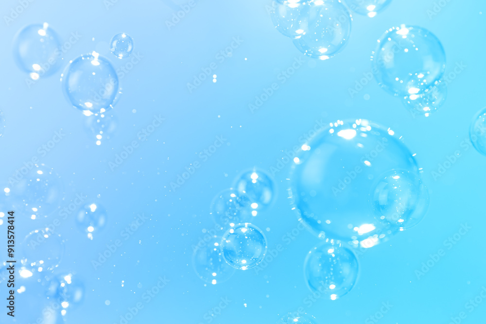 Beautiful Transparent Shiny Soap Bubbles Floating in The Air. Celebration Festive Backdrop. Freshness Soap Suds Bubbles Water. Abstract Blue Textured Background. Beautiful Transparent Shiny Soap Bubbles Floating in The Air. Celebration Festive Backdrop. Freshness Soap Suds Bubbles Water. Abstract Blue Textured Background.