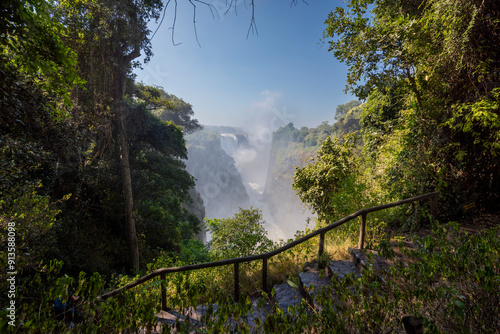 Victoria Falls, Mosi-oa-Tunya, is a waterfall on the Zambezi River, located on the border between Zambia and Zimbabwe. It is one of the world's largest waterfalls, with a width of 1,708 m