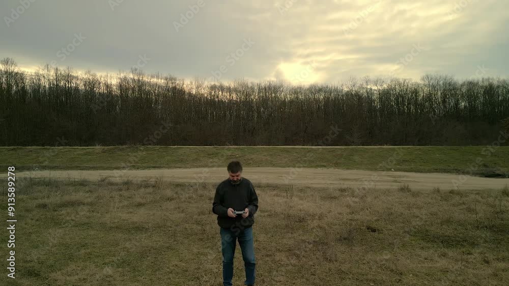 Confused beginner drone operator looks bewildered into remote control screen Confused beginner drone operator looks bewildered into remote control screen