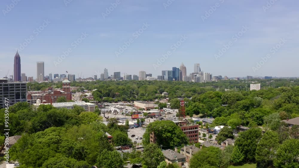 Aerial of Atlanta neighbourhood surrounded by green parks with Downtown Atlanta financial district skyline buildings Aerial of Atlanta neighbourhood surrounded by green parks with Downtown Atlanta financial district skyline buildings