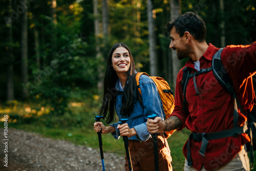 Obraz na plátně Shot of a happy young couple going for a romantic walk in the woods