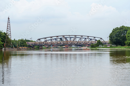 Landscape of evening sky and countryside scenery with Railway Saowabha Bridge over the Tha Chin River of Nakhon Chai Si, Nakhon Pathom Province Thailand. photo