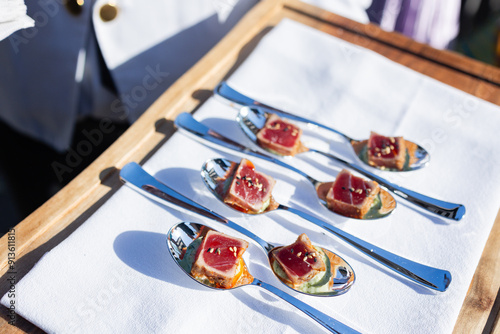 bite sized seared tuna served on individual spoons at event photo