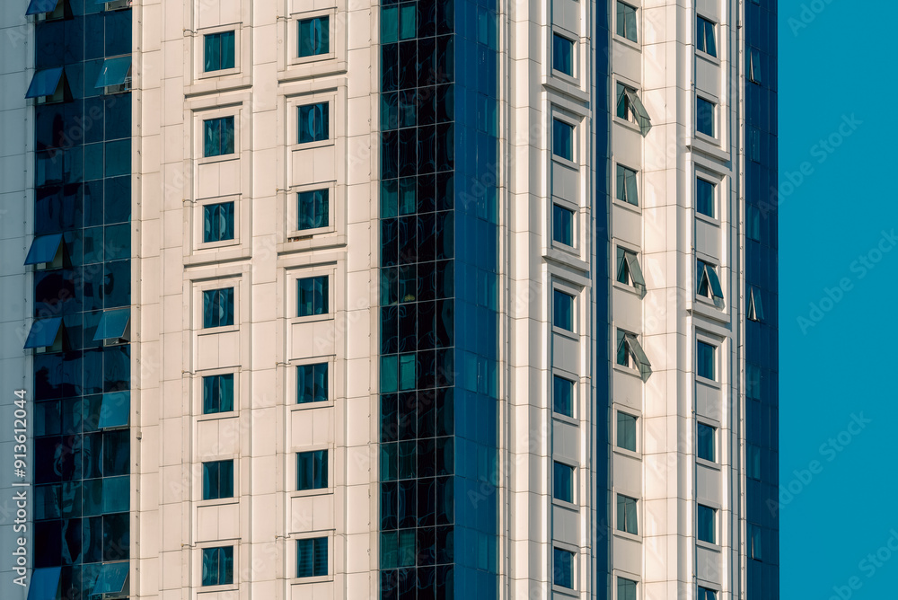 many windows and walls facade of a modern skyscraper without people many windows and walls facade of a modern skyscraper without people