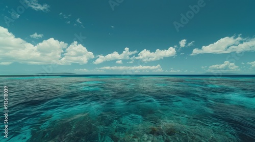 Clear Blue Ocean with Fluffy Clouds and a Distant Island