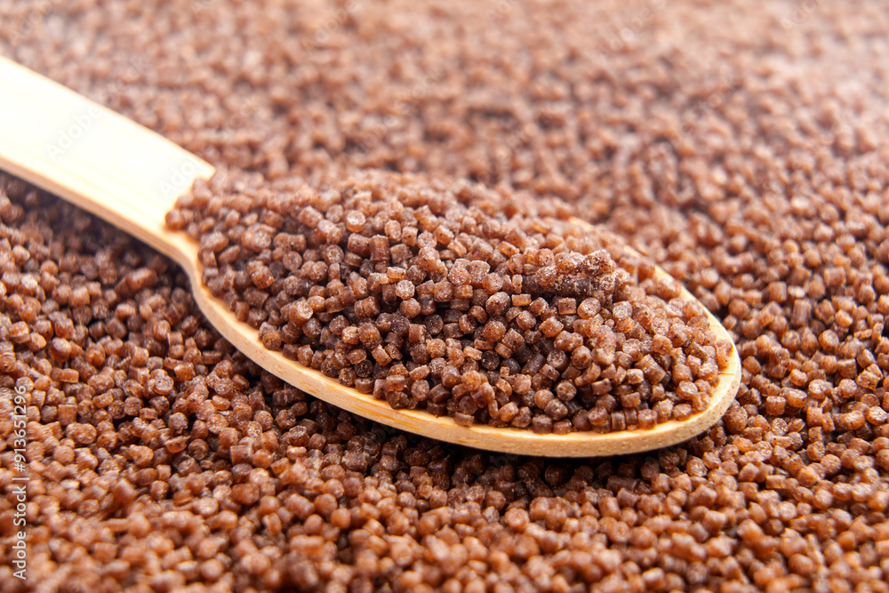 Organic gluten free buckwheat couscous grains in bamboo spoon. Organic gluten free buckwheat couscous grains in bamboo spoon.