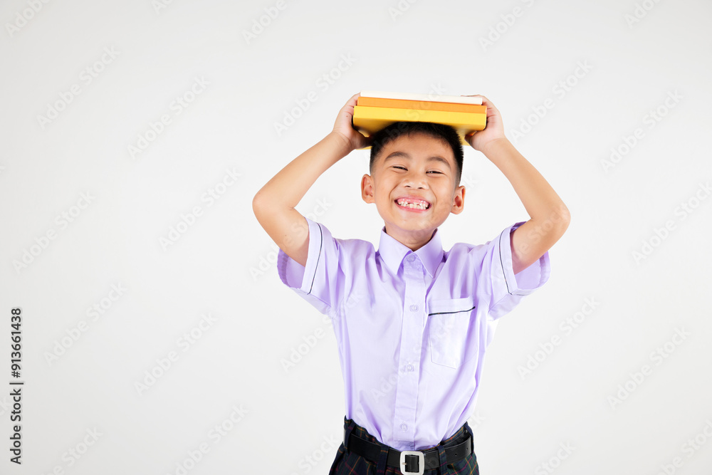 Portrait smiling Asian little boy primary posing holding book over head and screaming studio shot isolated white background, happy cute man kid wear school uniform pride, back to school concept Portrait smiling Asian little boy primary posing holding book over head and screaming studio shot isolated white background, happy cute man kid wear school uniform pride, back to school concept