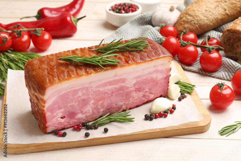 Piece of raw bacon with spices and cherry tomatoes on white wooden table Piece of raw bacon with spices and cherry tomatoes on white wooden table
