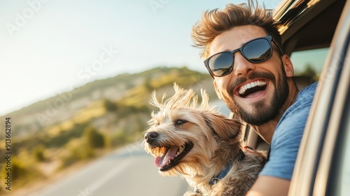 Smiling man wearing sunglasses, with his dog by his side, both leaning out of a car window at sunny day , seaside view