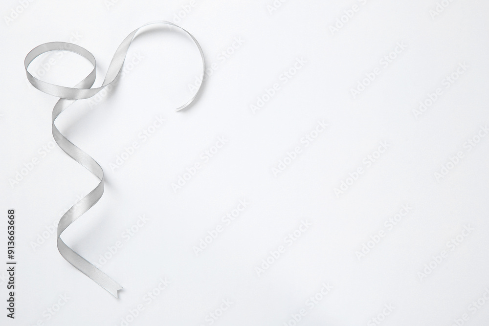 One beautiful grey ribbon on white background, top view. Space for text One beautiful grey ribbon on white background, top view. Space for text