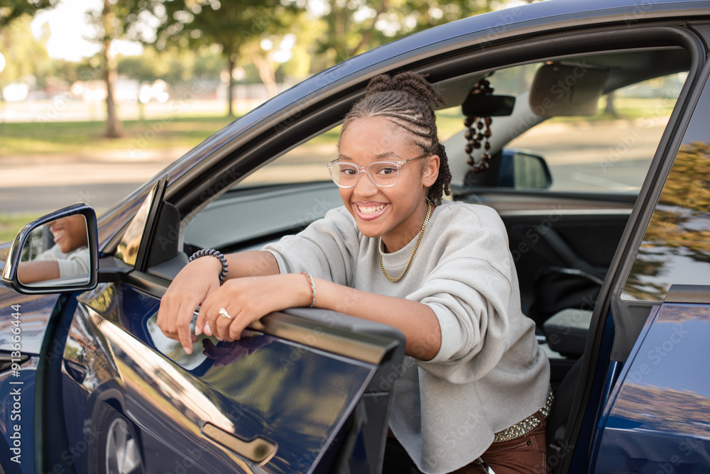Adult driver leaning on car door smiling Adult driver leaning on car door smiling