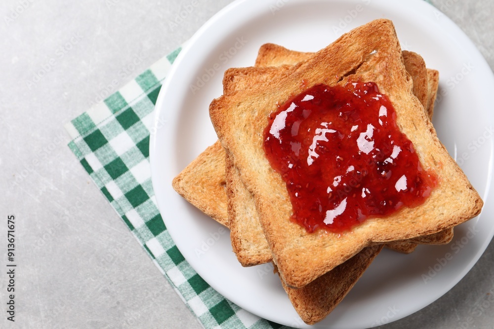 Delicious toasts with jam on light table, top view Delicious toasts with jam on light table, top view