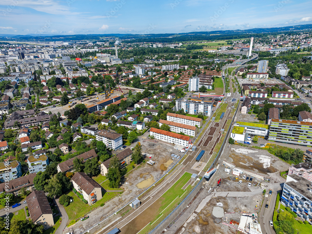Fototapeta premium Aerial view over Swiss City of Zürich with highway enclosure and public park on a sunny summer morning. Photo taken August 6th, 2024, Zurich, Switzerland.