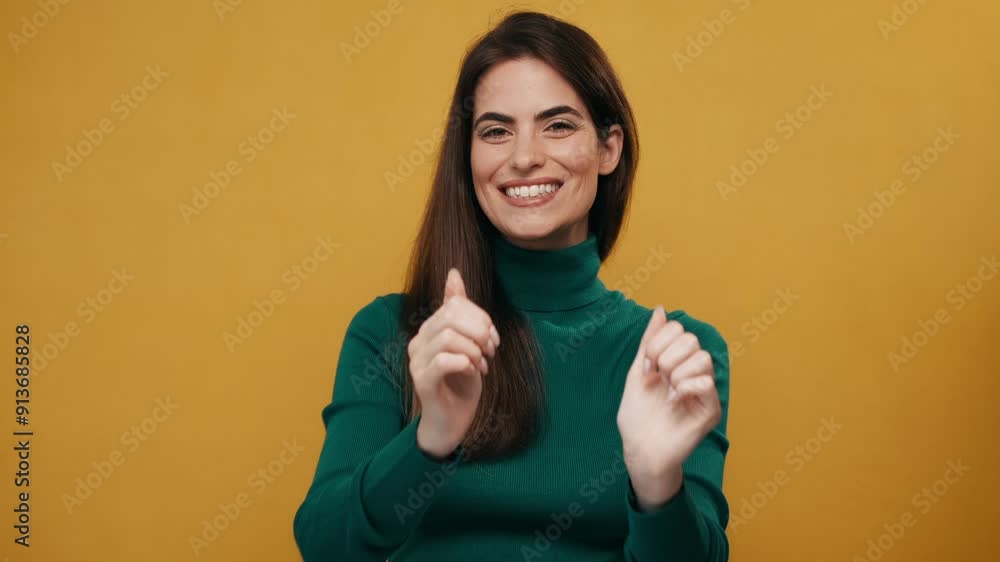 Video of positive beautiful woman doing ok gesturing with fingers while posing at the camera on isolated yellow Video of positive beautiful woman doing ok gesturing with fingers while posing at the camera on isolated yellow