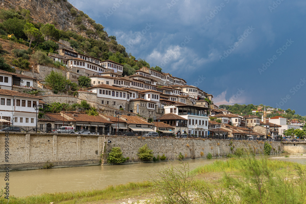 Obraz premium Sunset over the UNESCO town of Berat on the Osum River in Albania and known for its white Ottoman houses also called the city of One Over One Windows and built against the hill side below the citadel