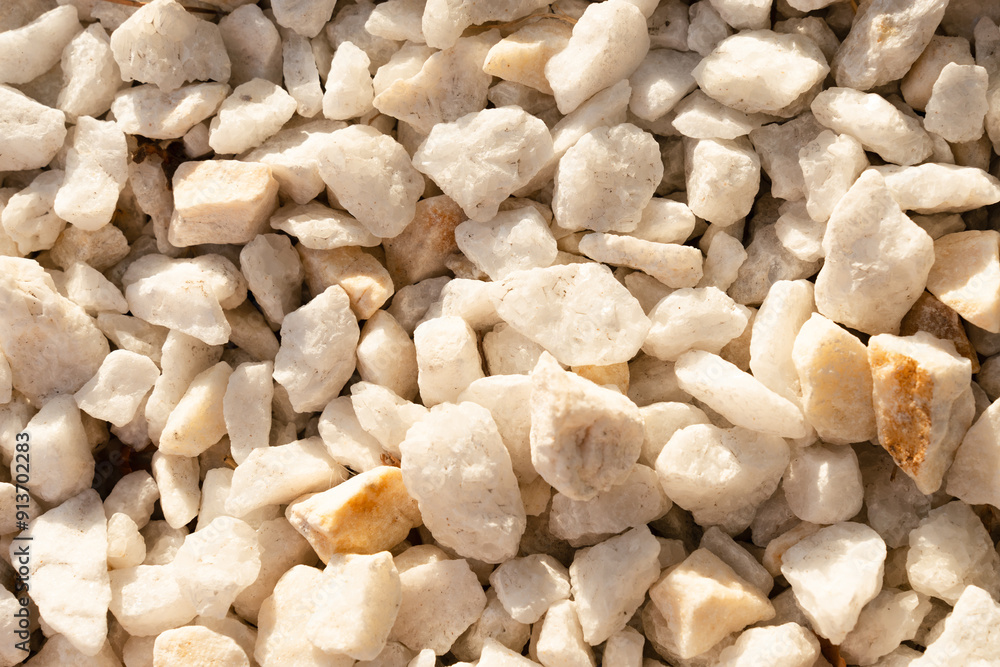 A close-up image of white gravel stones, ideal for backgrounds, textures, and construction-related themes. A close-up image of white gravel stones, ideal for backgrounds, textures, and construction-related themes.