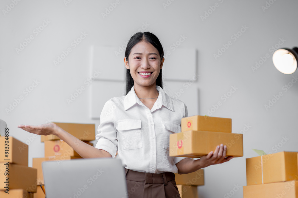 Startup SME small business asian entrepreneur SME or freelance Asian woman standing using a laptop,clipboard with box, online marketing packaging box and delivery, SME concept. Startup SME small business asian entrepreneur SME or freelance Asian woman standing using a laptop,clipboard with box, online marketing packaging box and delivery, SME concept.