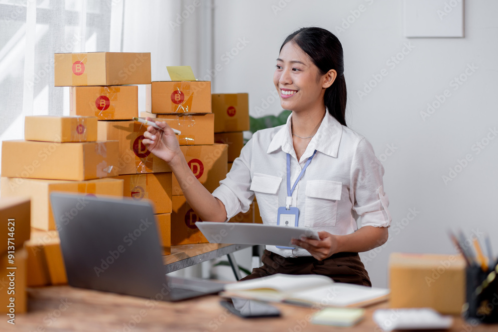 Sme Female ecommerce business owner prepares package box for customer and delivery check balance. asian SME, SME business ideas online. Sme Female ecommerce business owner prepares package box for customer and delivery check balance. asian SME, SME business ideas online.