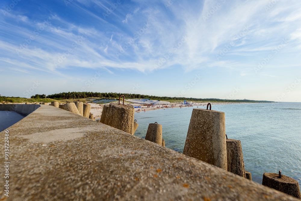 View of the western beach in Leba. Concrete breakwaters in the foreground. Beautiful sunny day. Leba, Poland