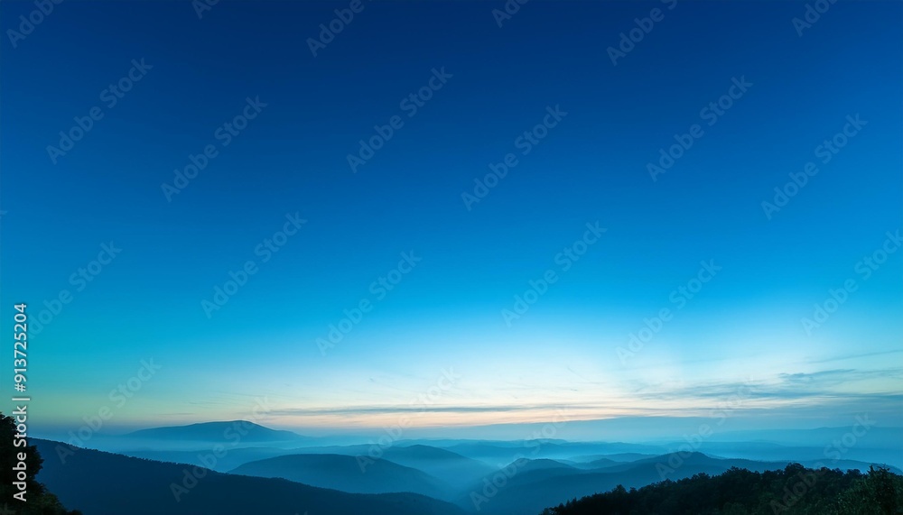 A breathtaking panoramic view of a vast mountain range at sunrise, with a clear blue sky and distant peaks bathed in golden light. A breathtaking panoramic view of a vast mountain range at sunrise, with a clear blue sky and distant peaks bathed in golden light.