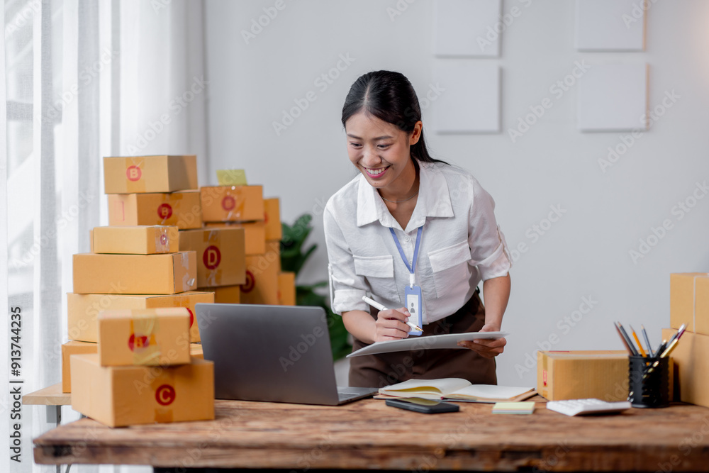 Excited happy asian woman working for smeproduction online at home with her laptop,she’s sme online seller. Excited happy asian woman working for smeproduction online at home with her laptop,she’s sme online seller.