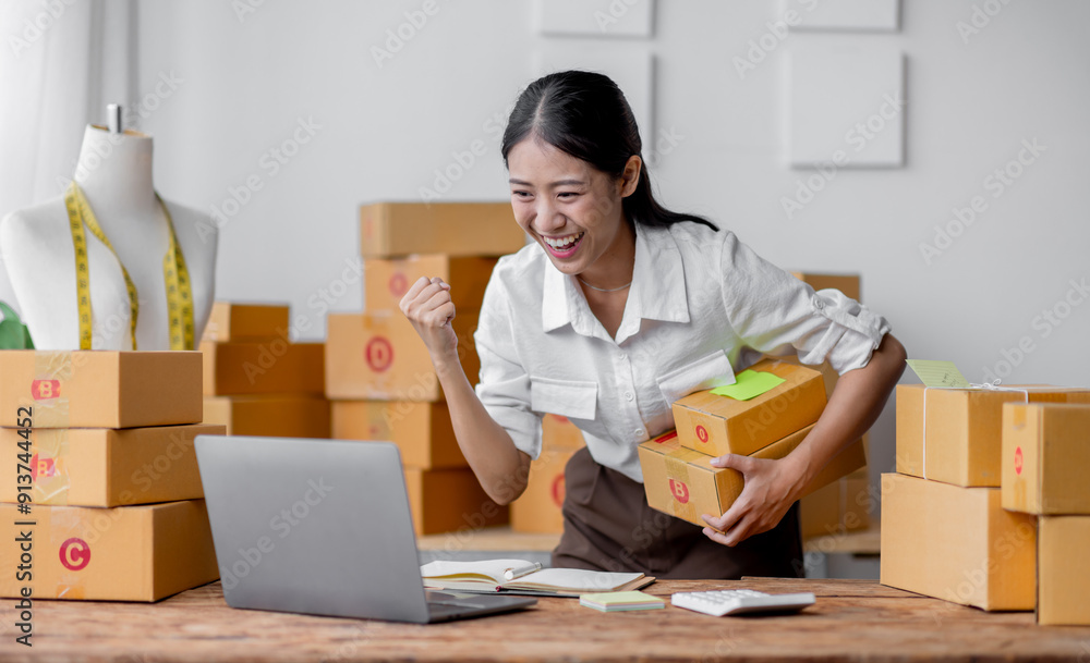 Excited happy asian woman working for smeproduction online at home with her laptop,she’s sme online seller. Excited happy asian woman working for smeproduction online at home with her laptop,she’s sme online seller.