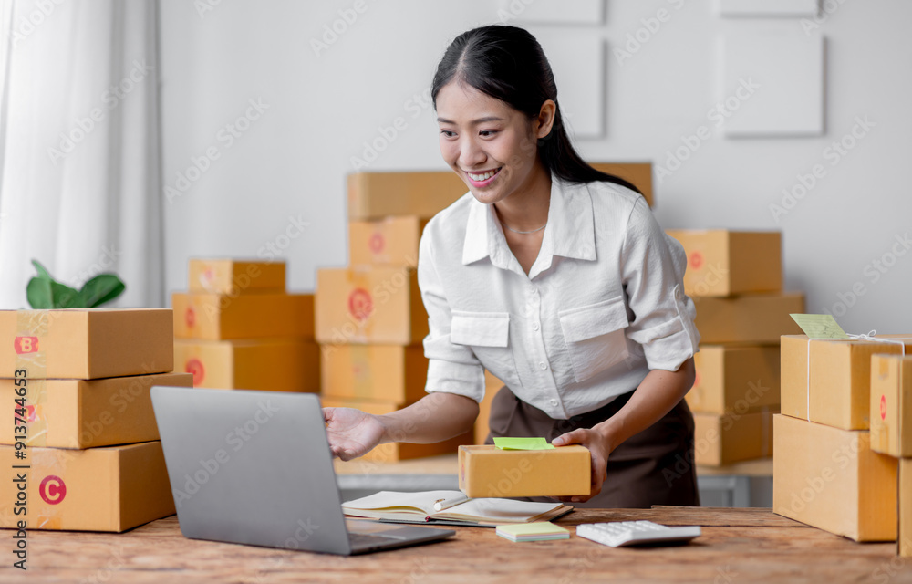 Excited happy asian woman working for smeproduction online at home with her laptop,she’s sme online seller. Excited happy asian woman working for smeproduction online at home with her laptop,she’s sme online seller.
