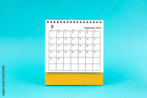 September 2024 desk calendar on blue background. photo