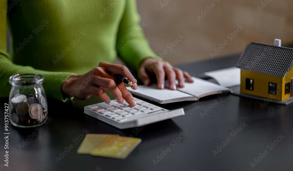 saving money, Real estate concept background. Hand of House model and coins stack on wooden table, Business and tax concept copy space. saving money, Real estate concept background. Hand of House model and coins stack on wooden table, Business and tax concept copy space.