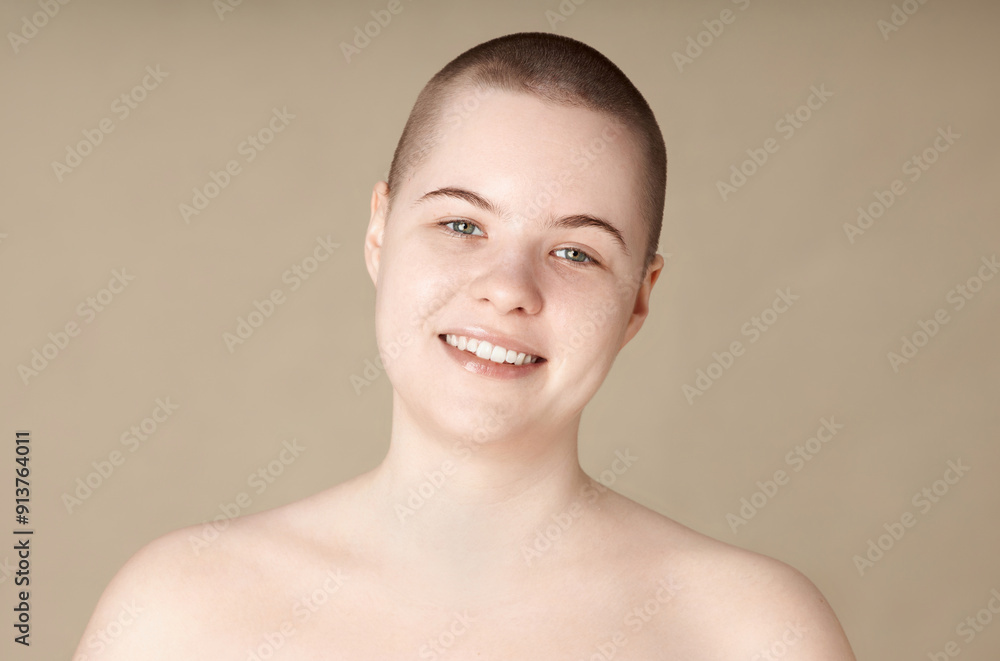 Minimal portrait of smiling young woman with short hair and no makeup looking at camera on neutral background copy space Minimal portrait of smiling young woman with short hair and no makeup looking at camera on neutral background copy space