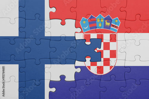 puzzle with the colourful national flag of croatia and flag of finland. photo