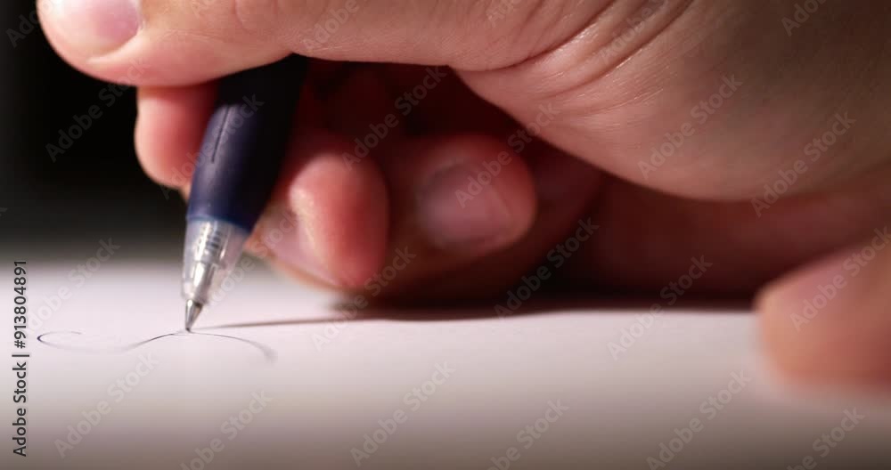 Blurry close-up of an individual's hand while scribbling some notes using a pen on a clean white sheet of paper. Blurry close-up of an individual's hand while scribbling some notes using a pen on a clean white sheet of paper.