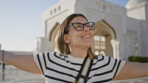 Smiling woman exploring qasr al watan in abu dhabi, uae, with palace architecture in the background photo