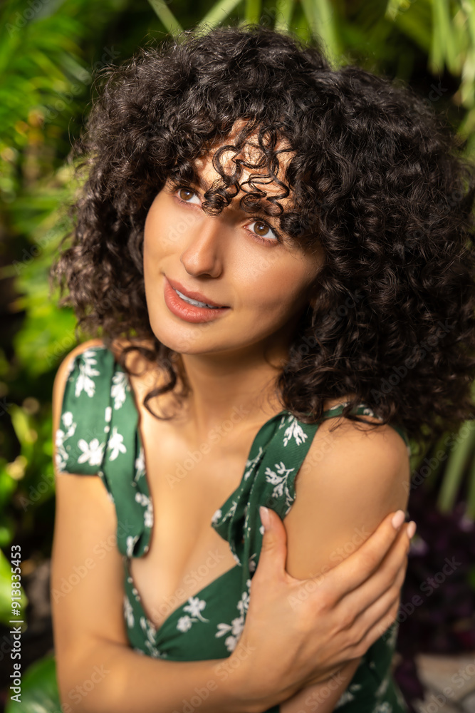 Female model with curly hair among tropical leaves spa and wellness atmosphere Female model with curly hair among tropical leaves spa and wellness atmosphere