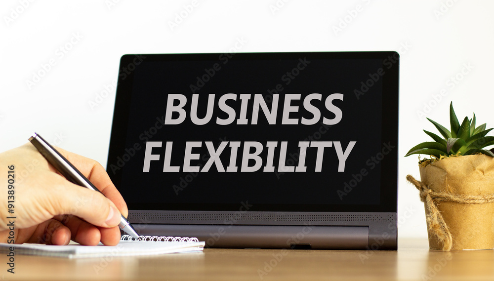 Business flexibility symbol. Concept words Business flexibility on beautiful black pad. Beautiful white background. Businessman hand. Business flexibility concept. Copy space. Business flexibility symbol. Concept words Business flexibility on beautiful black pad. Beautiful white background. Businessman hand. Business flexibility concept. Copy space.