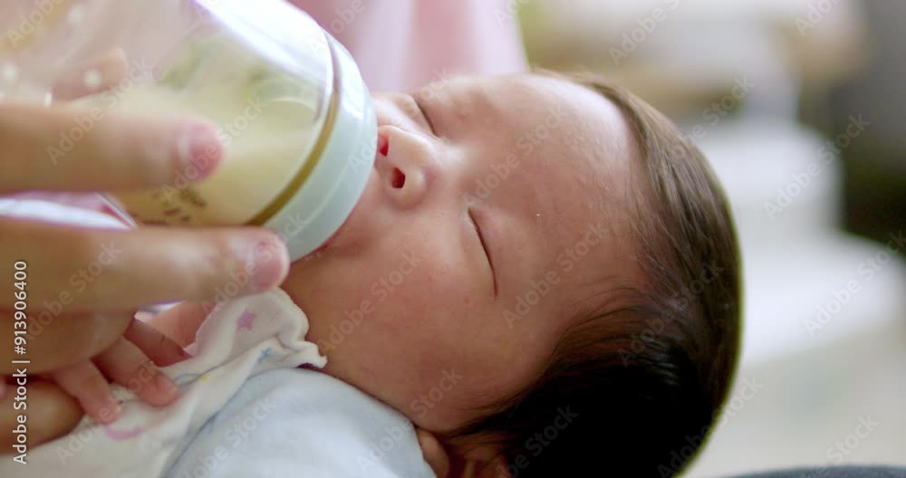 Baby born with eyes closed being bottle fed. Baby born with eyes closed being bottle fed.