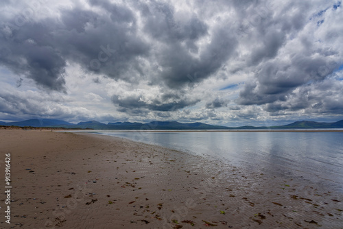 Dark clouds over Llanddwyn beach, Anglesey, at low tide. photo