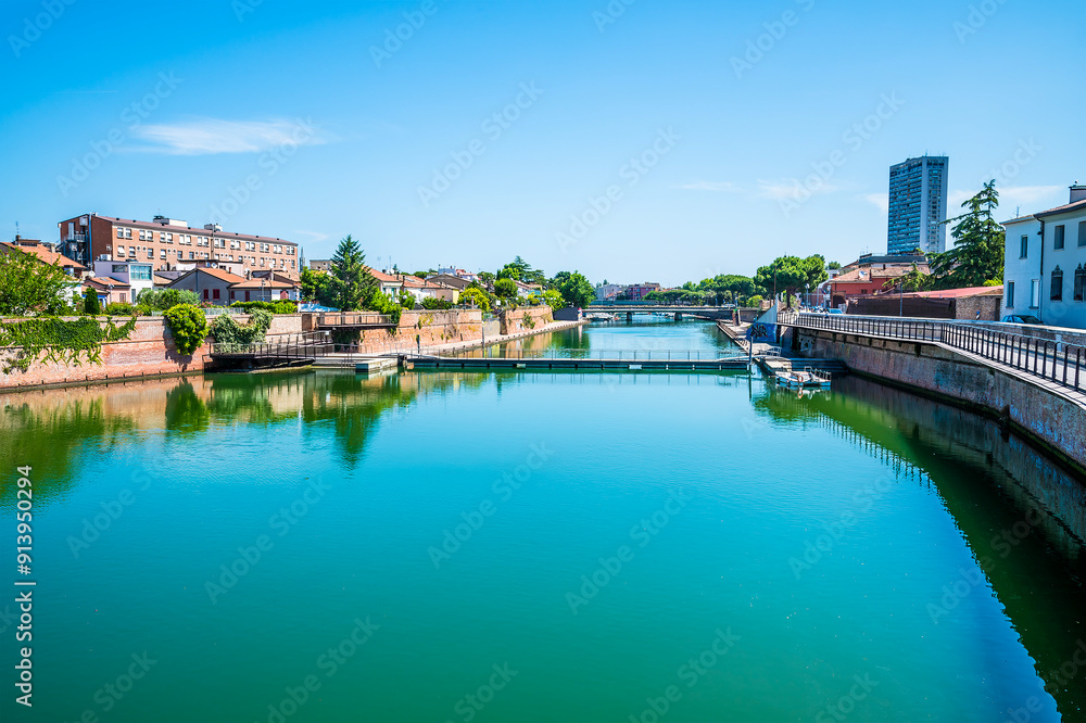 A view from the Roman Tiberius Bridge along the estuary out to sea at Rimini, Italy in summertime A view from the Roman Tiberius Bridge along the estuary out to sea at Rimini, Italy in summertime